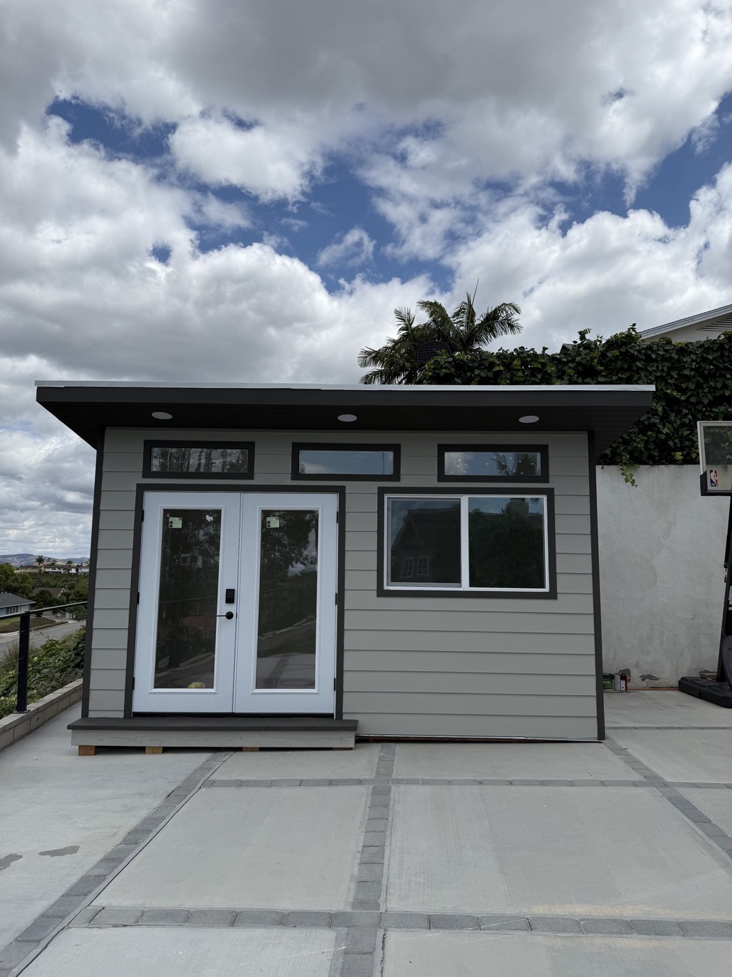 Grey 8 by 15 ft backyard office with a row of transom windows